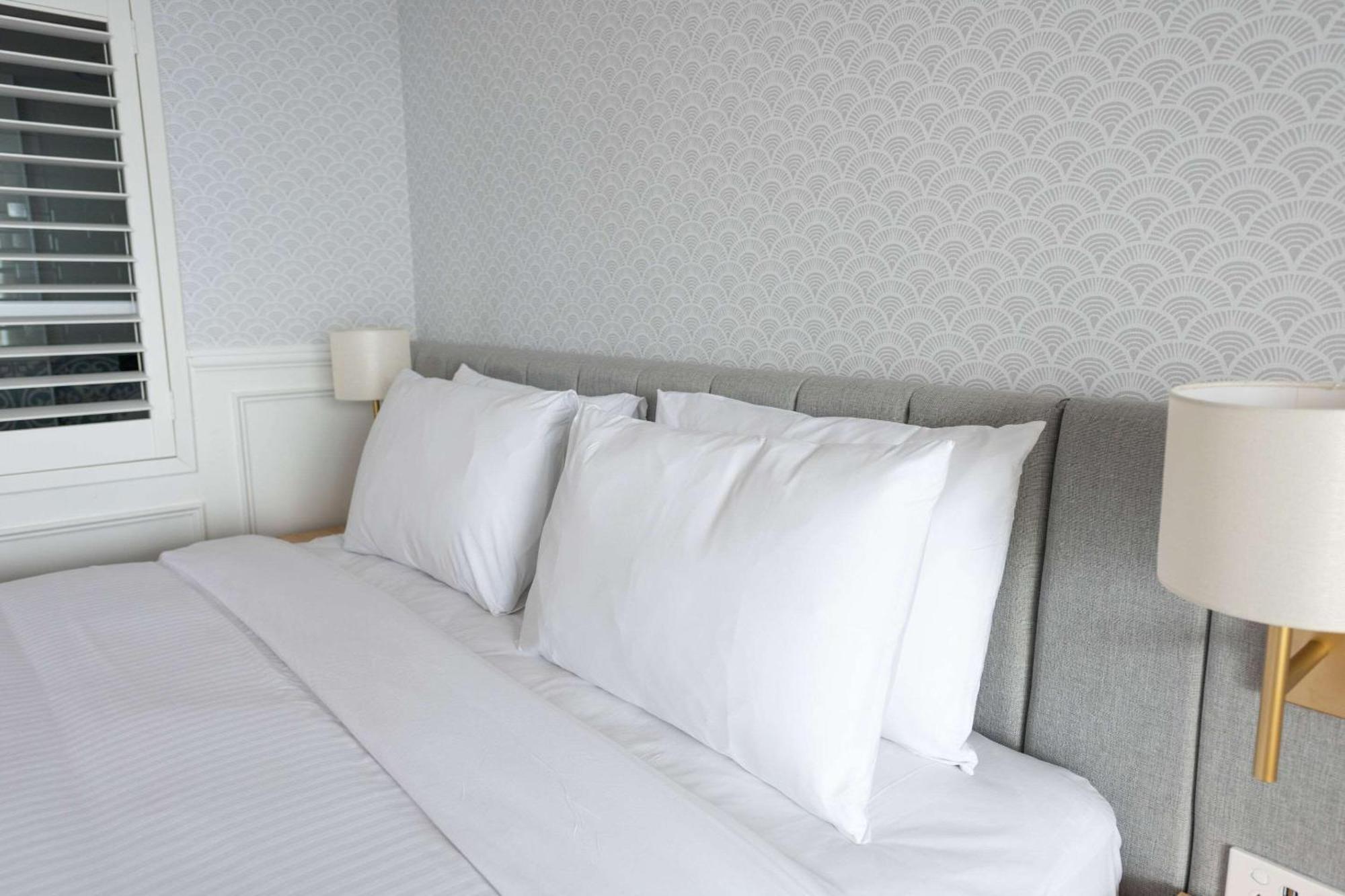 The Beachcomber Hotel & Resort, Ascend Hotel Collection Toukley Kültér fotó Pillows on a bed
